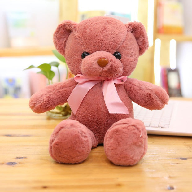 Colorful Bear Doll Plush Toys in various shades including pink, blue, purple, and green displayed on shelves and a chair, perfect for gifting or cuddling.