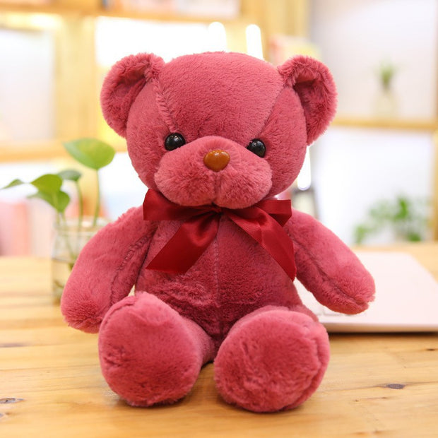 Colorful Bear Doll Plush Toys in various shades including pink, blue, purple, and green displayed on shelves and a chair, perfect for gifting or cuddling.