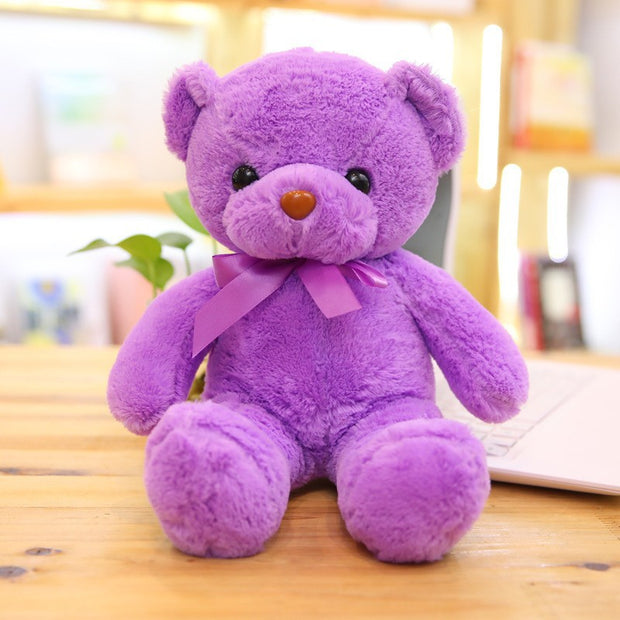 Colorful Bear Doll Plush Toys in various shades including pink, blue, purple, and green displayed on shelves and a chair, perfect for gifting or cuddling.