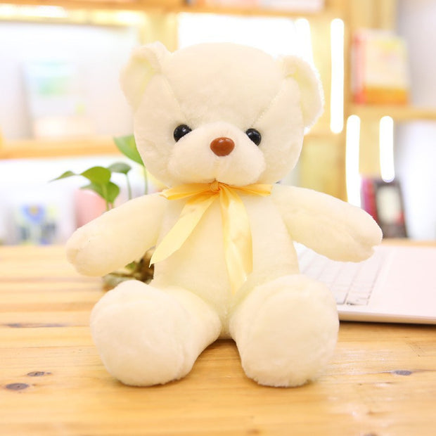 Colorful Bear Doll Plush Toys in various shades including pink, blue, purple, and green displayed on shelves and a chair, perfect for gifting or cuddling.