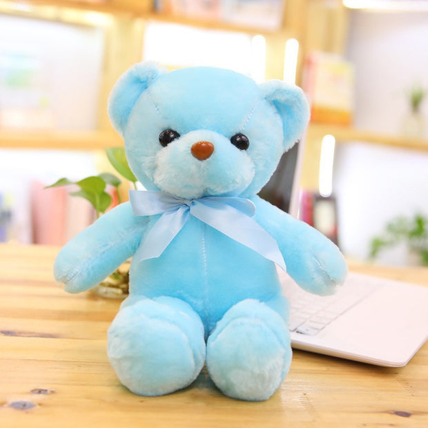 Colorful Bear Doll Plush Toys in various shades including pink, blue, purple, and green displayed on shelves and a chair, perfect for gifting or cuddling.