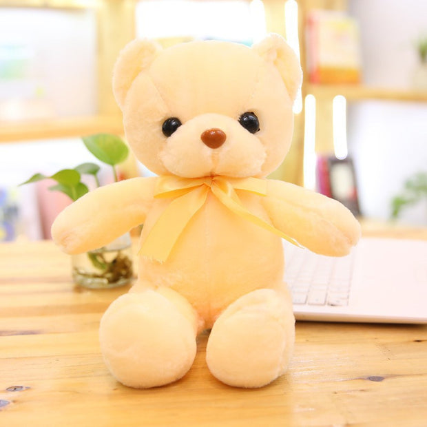 Colorful Bear Doll Plush Toys in various shades including pink, blue, purple, and green displayed on shelves and a chair, perfect for gifting or cuddling.