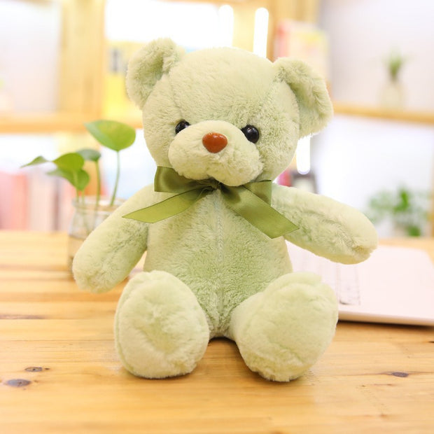 Colorful Bear Doll Plush Toys in various shades including pink, blue, purple, and green displayed on shelves and a chair, perfect for gifting or cuddling.