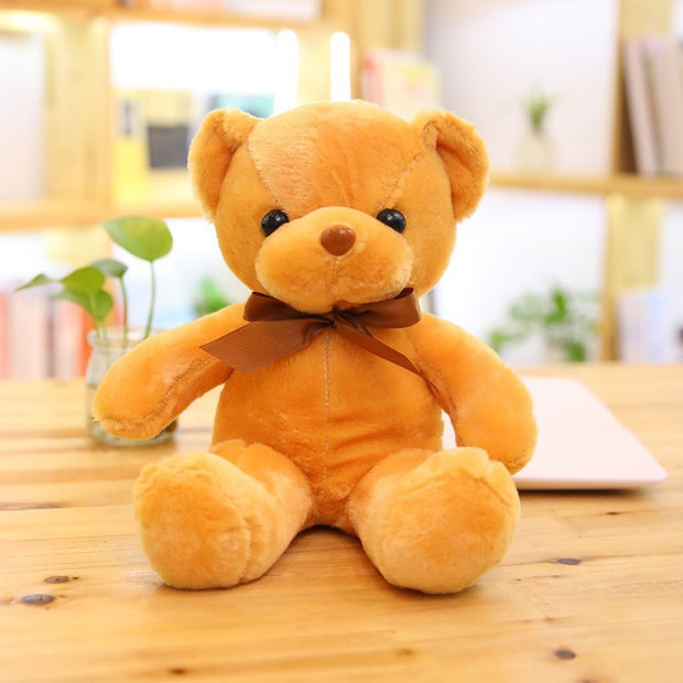 Colorful Bear Doll Plush Toys in various shades including pink, blue, purple, and green displayed on shelves and a chair, perfect for gifting or cuddling.