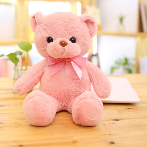 Colorful Bear Doll Plush Toys in various shades including pink, blue, purple, and green displayed on shelves and a chair, perfect for gifting or cuddling.